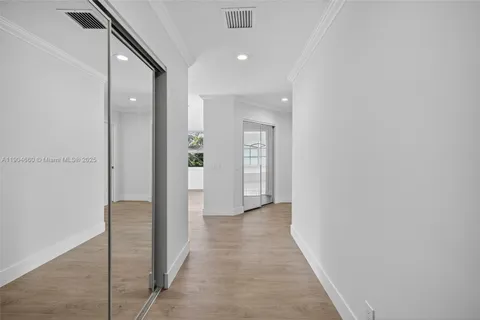 a view of a hallway with wooden shelves