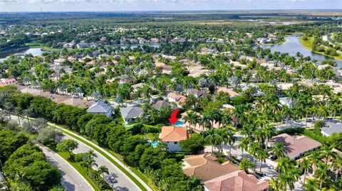 an aerial view of residential houses with outdoor space and trees