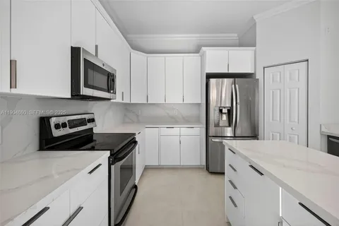 a kitchen with a sink stove and refrigerator