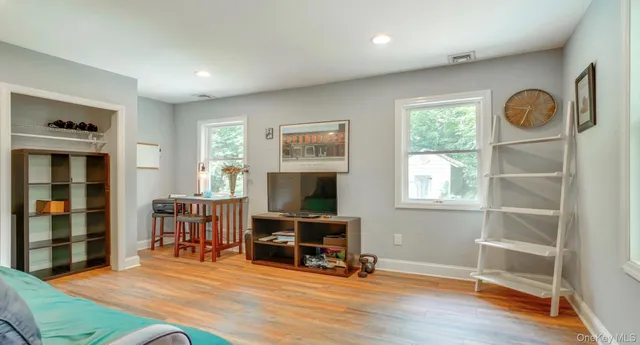 a view of a livingroom with furniture and a window