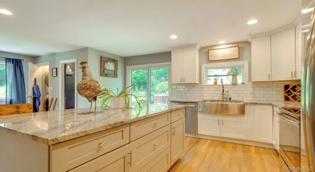 a kitchen with counter top space and wooden floor