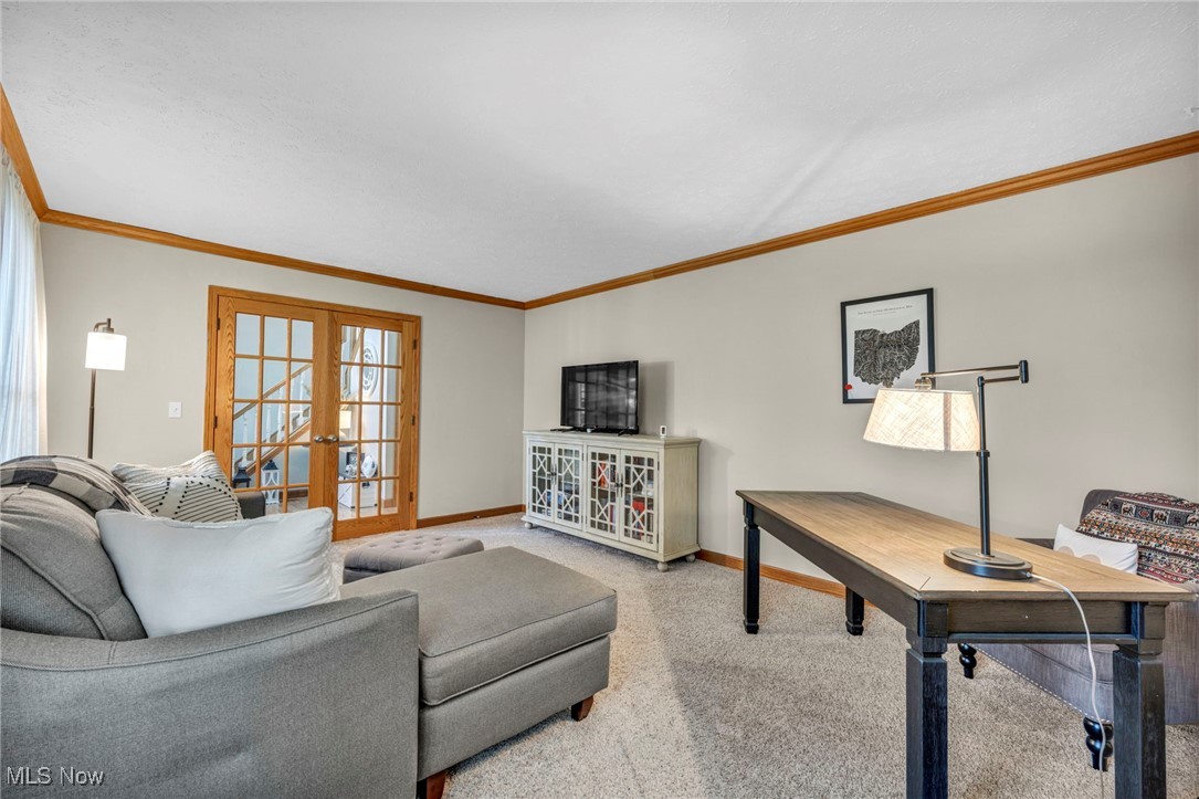 14902 Kneisel Road Vermilion, OH 44089 - Photo 7 of 49 Carpeted living room with french doors and ornamental molding