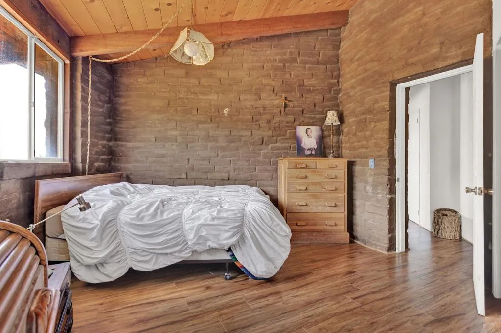 2951 Miramontes Road Jamul, CA 91935 - Photo 15 of 24 a bedroom with a bed and wooden floor