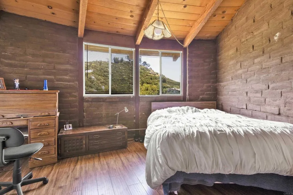 2951 Miramontes Road Jamul, CA 91935 - Photo 16 of 24 a bedroom with a bed and a large window
