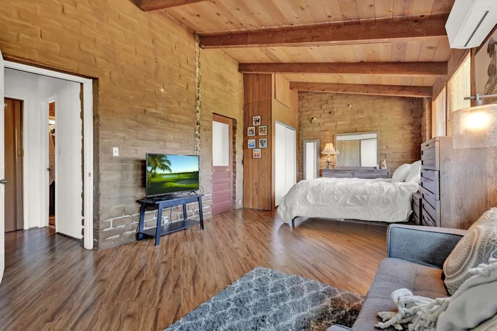 2951 Miramontes Road Jamul, CA 91935 - Photo 19 of 24 a bedroom with a bed and wooden floor