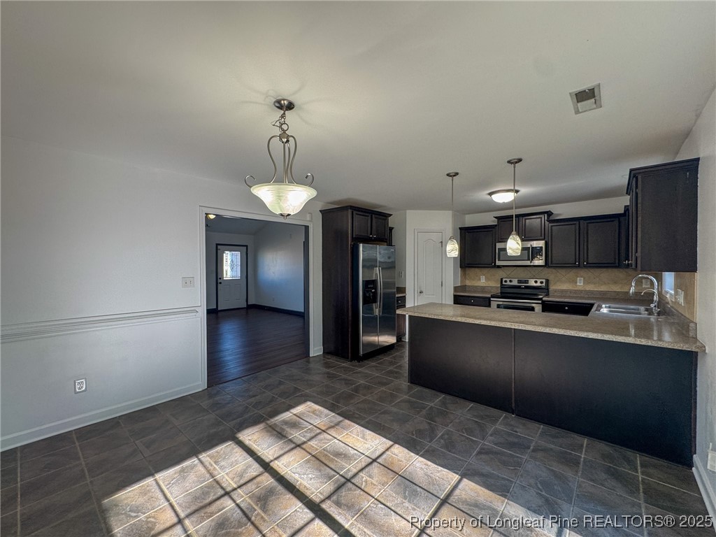 142 Crestwood Lane Raeford, NC 28376 - Photo 11 of 30 a large kitchen with stainless steel appliances kitchen island granite countertop a sink and cabinets