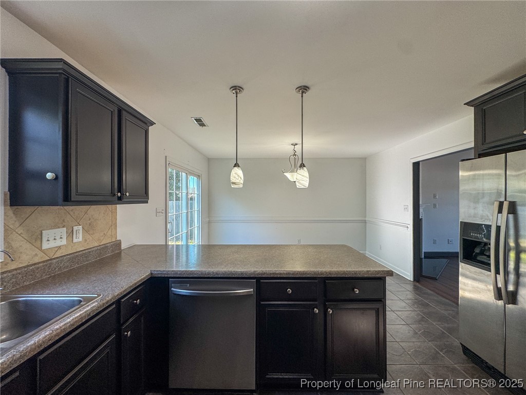 142 Crestwood Lane Raeford, NC 28376 - Photo 15 of 30 a kitchen with a sink and a refrigerator