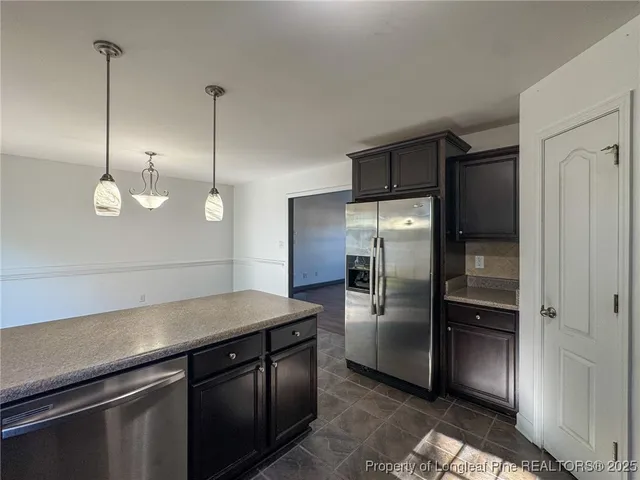 a kitchen with a refrigerator and a sink