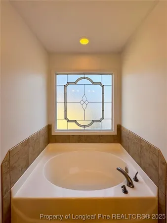 a bathroom with a tub and shower