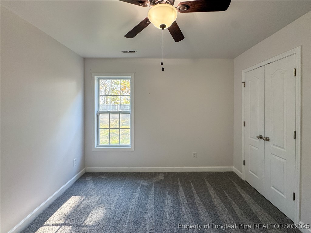 142 Crestwood Lane Raeford, NC 28376 - Photo 27 of 30 a view of empty room with wooden floor and fan