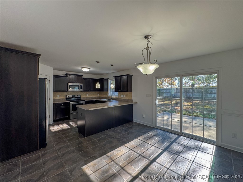 142 Crestwood Lane Raeford, NC 28376 - Photo 9 of 30 a large kitchen with kitchen island a large counter space a sink appliances and cabinets