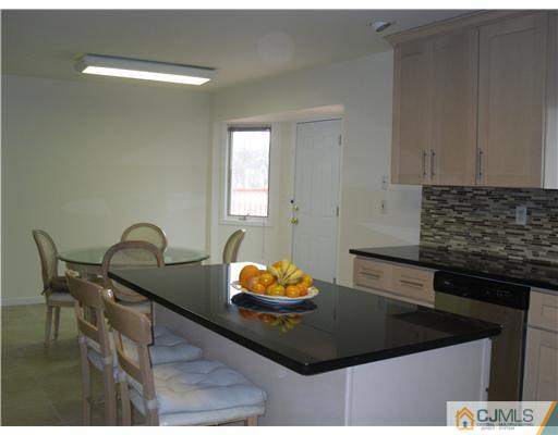2 Mindy Road Edison, NJ 08820 - Photo 12 of 25 a kitchen with granite countertop a sink a stove and a dining table