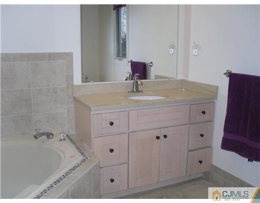2 Mindy Road Edison, NJ 08820 - Photo 18 of 25 a bathroom with a tub sink and mirror