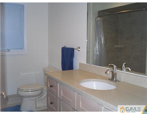 2 Mindy Road Edison, NJ 08820 - Photo 21 of 25 a bathroom with a granite countertop sink toilet and shower