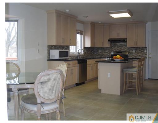 2 Mindy Road Edison, NJ 08820 - Photo 9 of 25 a kitchen with granite countertop a stove a sink and a microwave