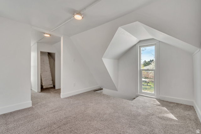 8831 South 400 East Sandy, UT 84070 - Photo 23 of 26 Bonus room featuring light carpet and lofted ceiling