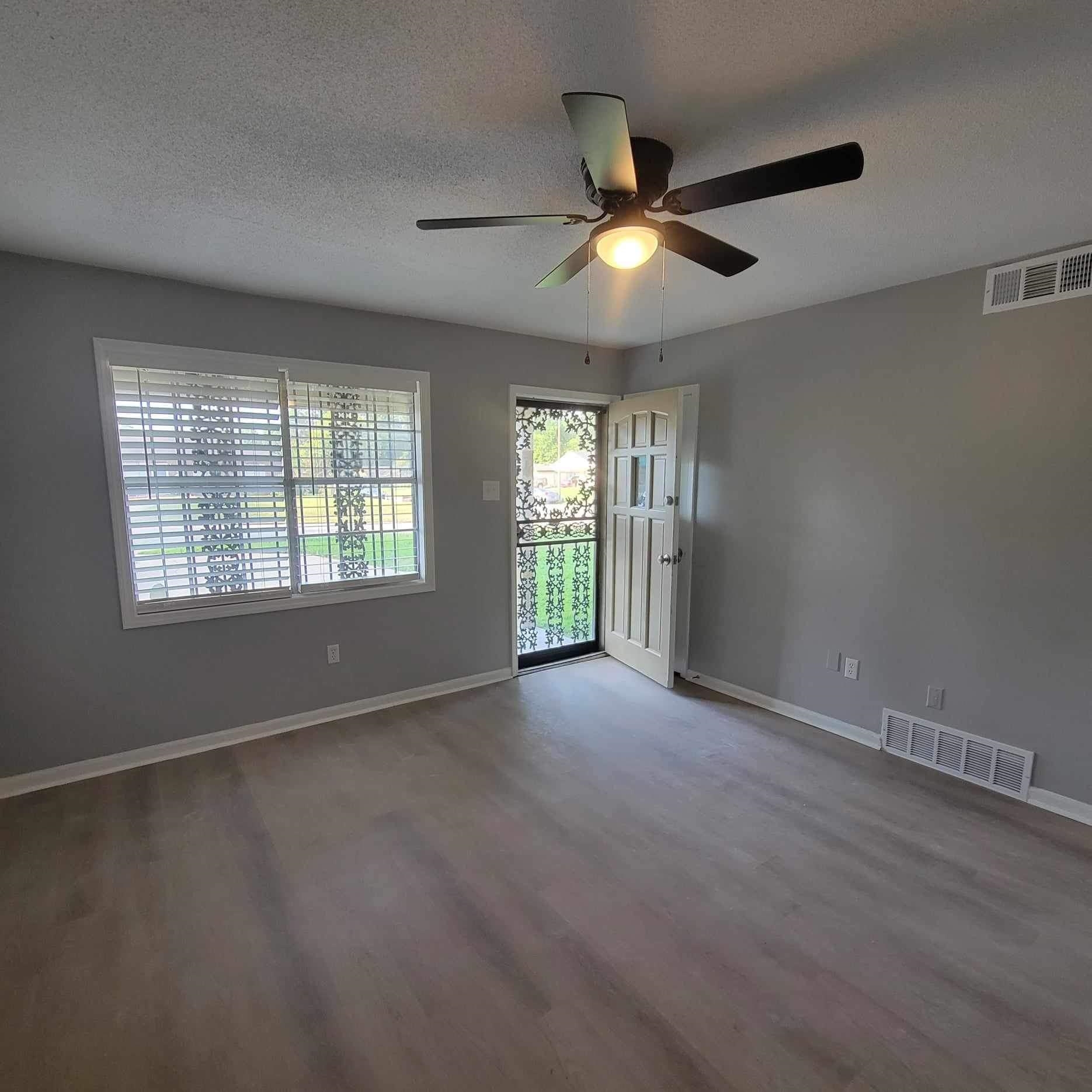 222 Pickett Road Memphis, TN 38109 - Photo 4 of 8 a view of an empty room with a window