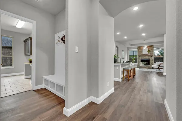 a view of a kitchen center island wooden floor and living room