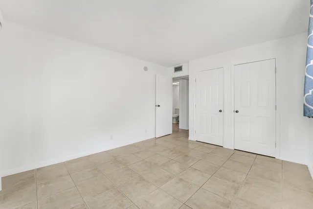 a bathroom with a toilet sink vanity and mirror