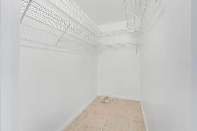 a view of a kitchen with wooden floor and a window