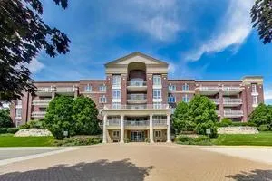 front view of a brick house with a yard