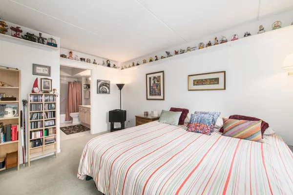 a bedroom with bed and cabinets