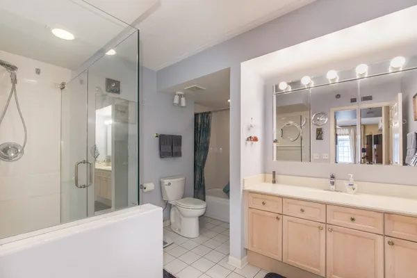 a spacious bathroom with a double vanity sink mirror and toilet