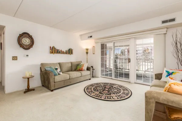 a living room with furniture a table and a large window