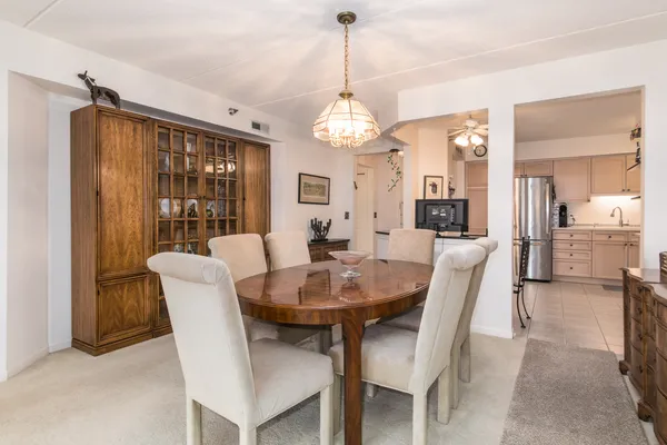 a view of a dining room with furniture and a chandelier