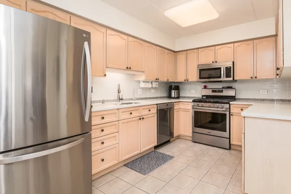 a kitchen with white cabinets and white appliances