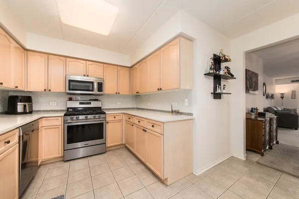 a kitchen with granite countertop a sink and steel appliances