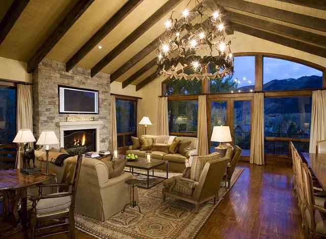 1033 Willoughby Way Aspen, CO 81612 - Photo 1 of 9 a living room with furniture a fireplace and a dining table with wooden floor