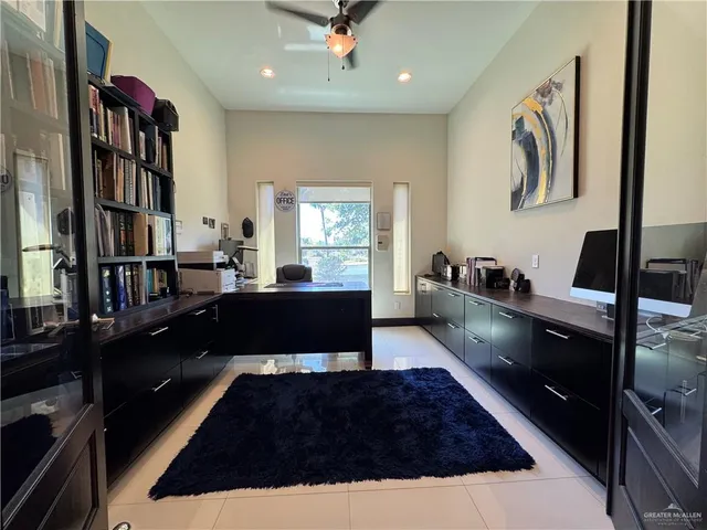 a large kitchen with a counter space a sink and cabinets