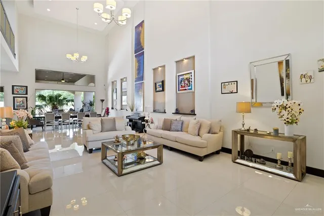 a living room with furniture and a chandelier