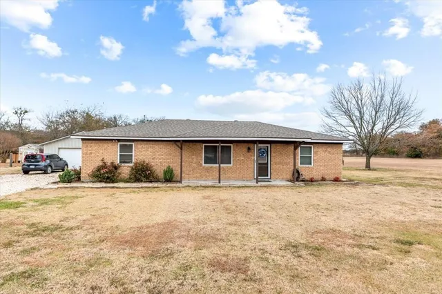 a house that has a tree in front of it
