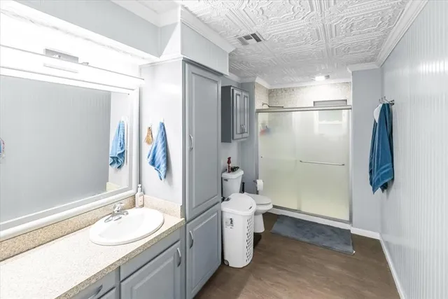 a bathroom with a granite countertop sink toilet and shower