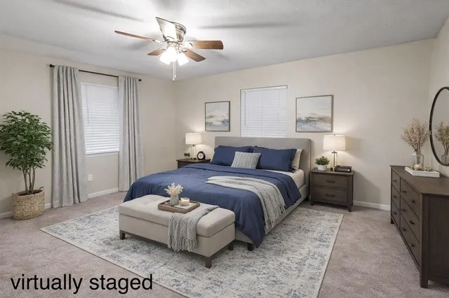 a bedroom with a bed and a potted plant