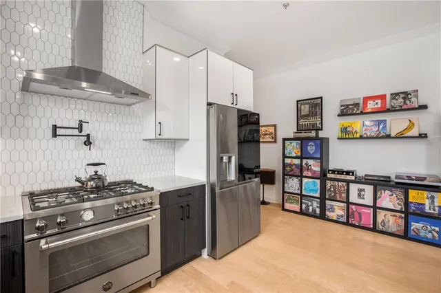 a large kitchen with a large counter top sink appliances and cabinets