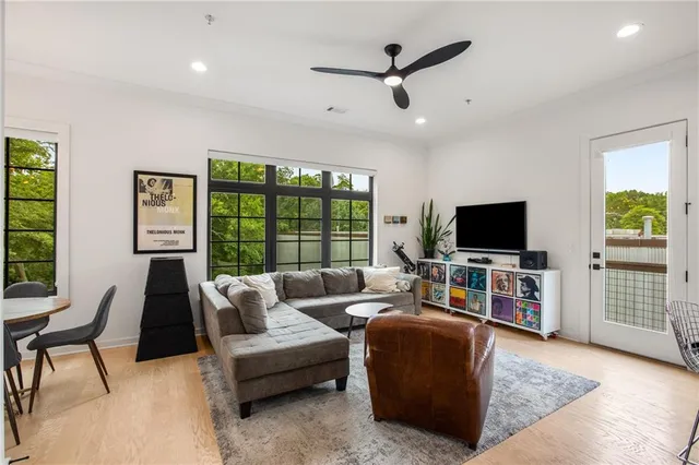 a living room with furniture a ceiling fan and a rug