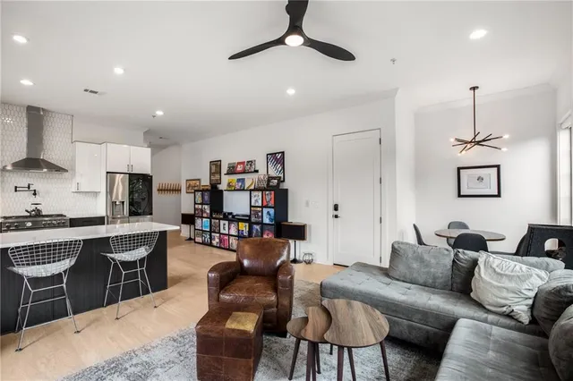 a kitchen with a dining table chairs and refrigerator