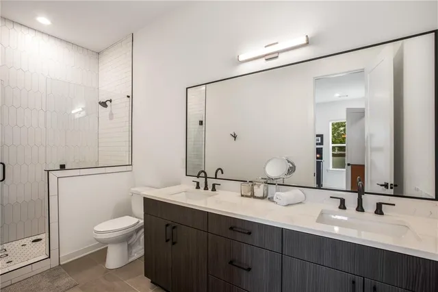 a bathroom with a sink toilet and shower