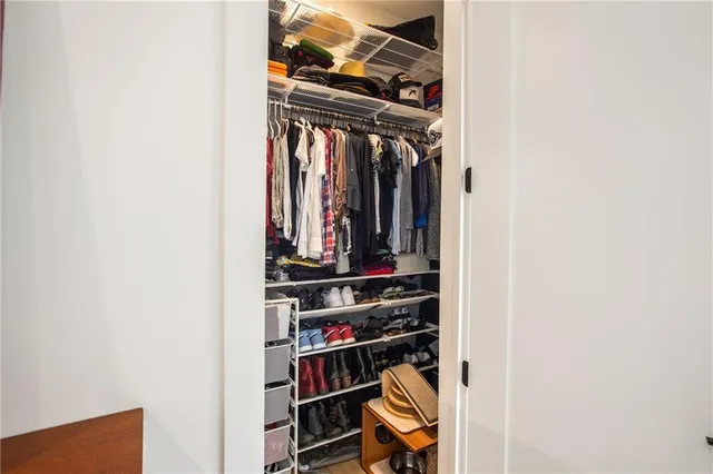 a bedroom with bed and a baby crib