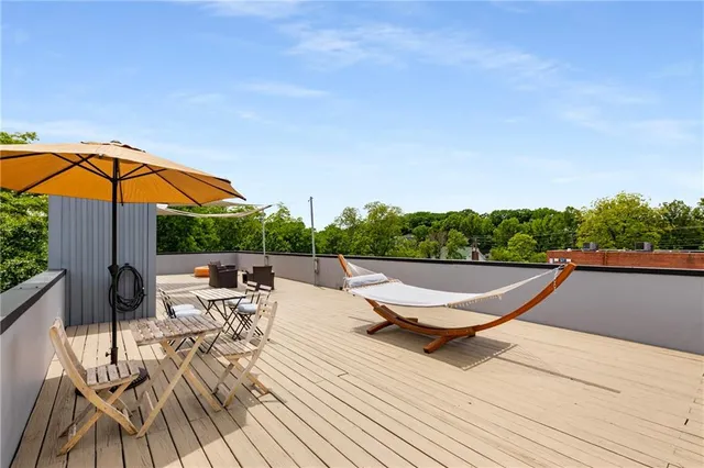 a view of balcony with seating space and wooden floor