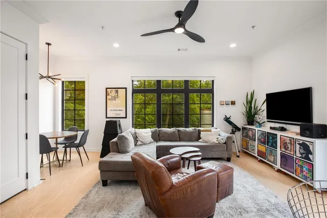 a kitchen with kitchen island granite countertop a sink refrigerator and cabinets