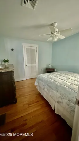 a bedroom with a bed dresser and a window