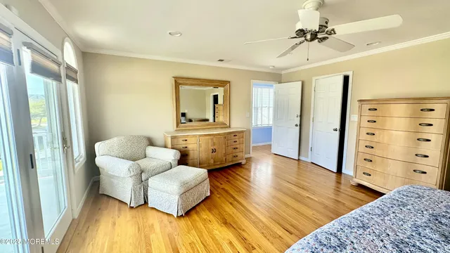 a spacious bedroom with a bed and a dresser