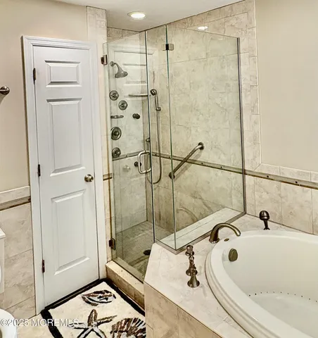a bathroom with a tub and a shower
