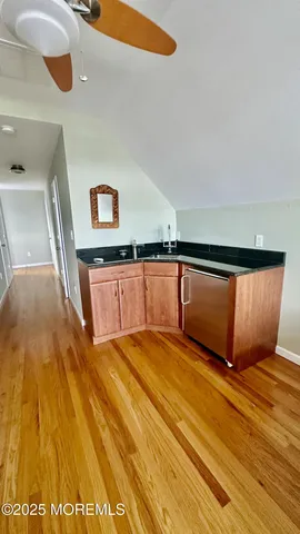 a view of a room with wooden floor and potted plant