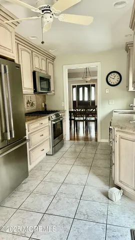a kitchen with stainless steel appliances a stove refrigerator sink and microwave