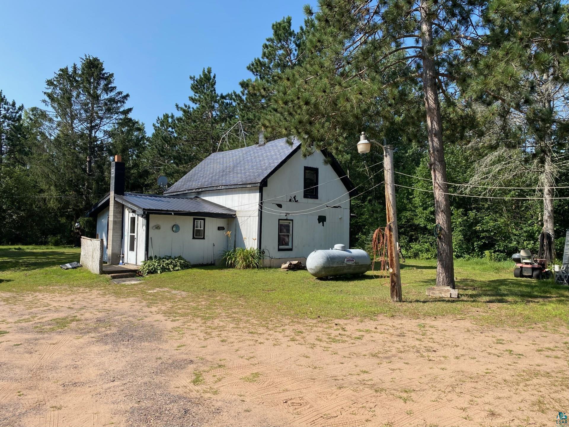 W6402 Old Bass Lake Road Minong, WI 54859 - Photo 4 of 18 Exterior space with a lawn